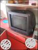 Black CRT TV With Brown Wooden TV Hutch