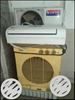 White Split-type Air Conditioner And Beige Portable Air Conditioner